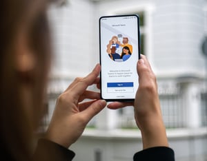 Image of a person accessing Microsoft Teams on their mobile phone