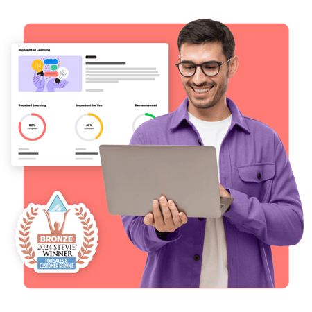 Smiling Customer Success Operations professional holding a laptop, standing near a module progress page with radial bar charts showing percentage complete. A Bronze 2024 Stevie Winner logo is in the lower corner.