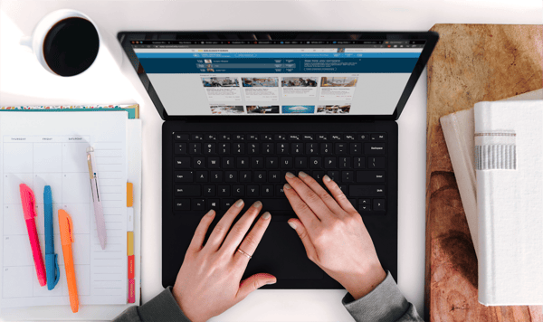 Hands on a laptop keyboard with an online learning solution on the screen