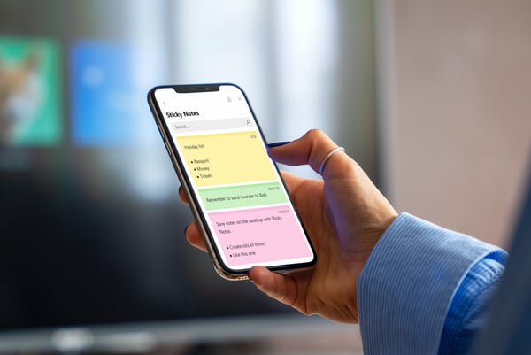 A mobile phone with the Sticky Notes app on the display