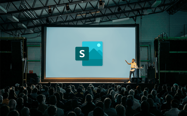 A person presenting with Microsoft Sway on a big screen behind them.