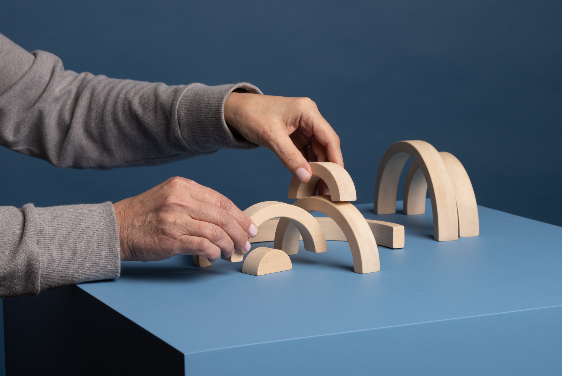 A woman using arched building blocks